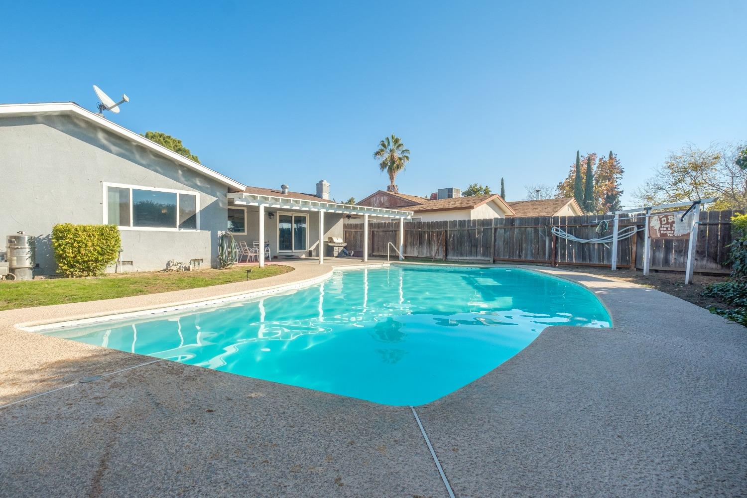 172 West Swift Avenue Clovis, CA 93612 - Photo 20 of 22 a view of a house with a swimming pool