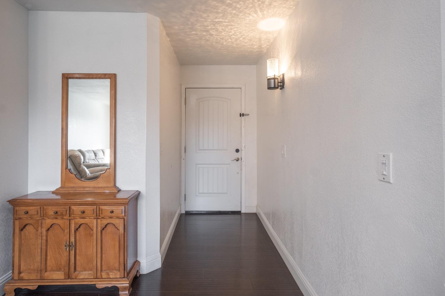 172 West Swift Avenue Clovis, CA 93612 - Photo 4 of 22 a view of front door with wooden floor