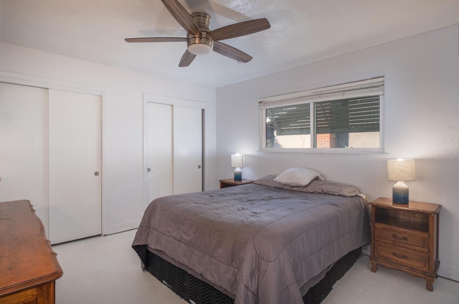 172 West Swift Avenue Clovis, CA 93612 - Photo 10 of 22 a bedroom with a bed and a chandelier