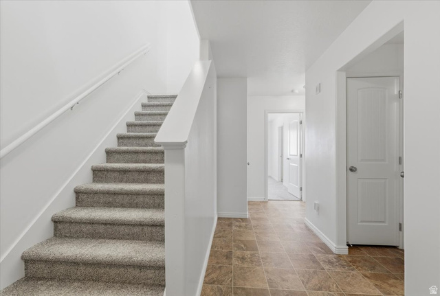 1218 Moonlight Drive Elk Ridge, UT 84651 - Photo 4 of 44 Staircase with baseboards and stone finish floors