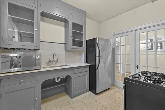 a kitchen with stainless steel appliances granite countertop a refrigerator and a sink