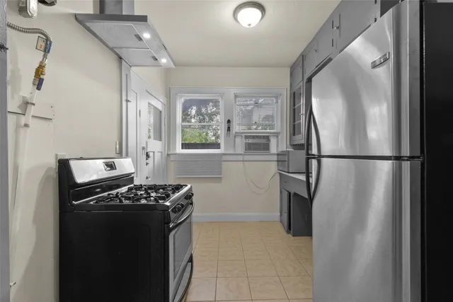 a kitchen with a refrigerator and a stove