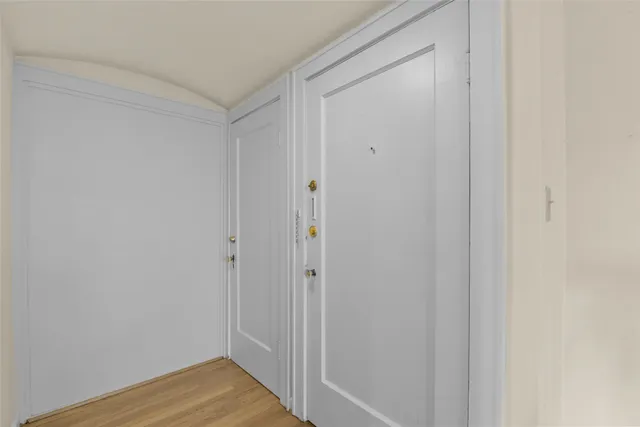 a view of a hallway with wooden floor