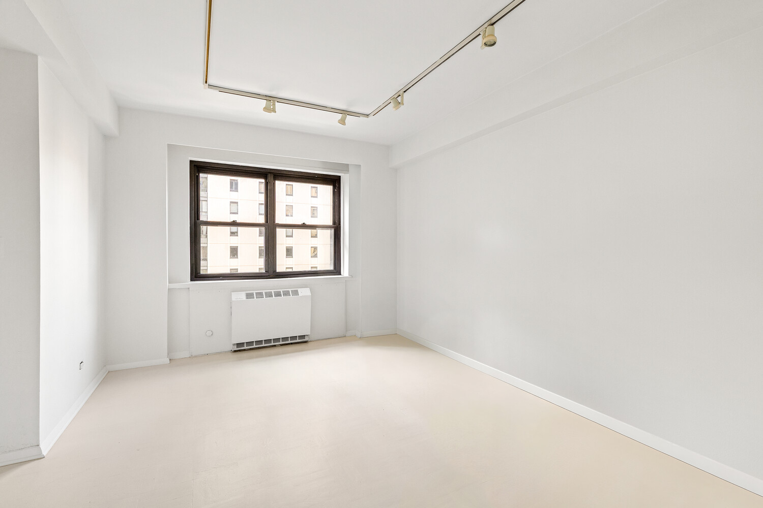 165 East 72nd Street, Unit 11C Manhattan, NY 10021 - Photo 10 of 12 an empty room with windows