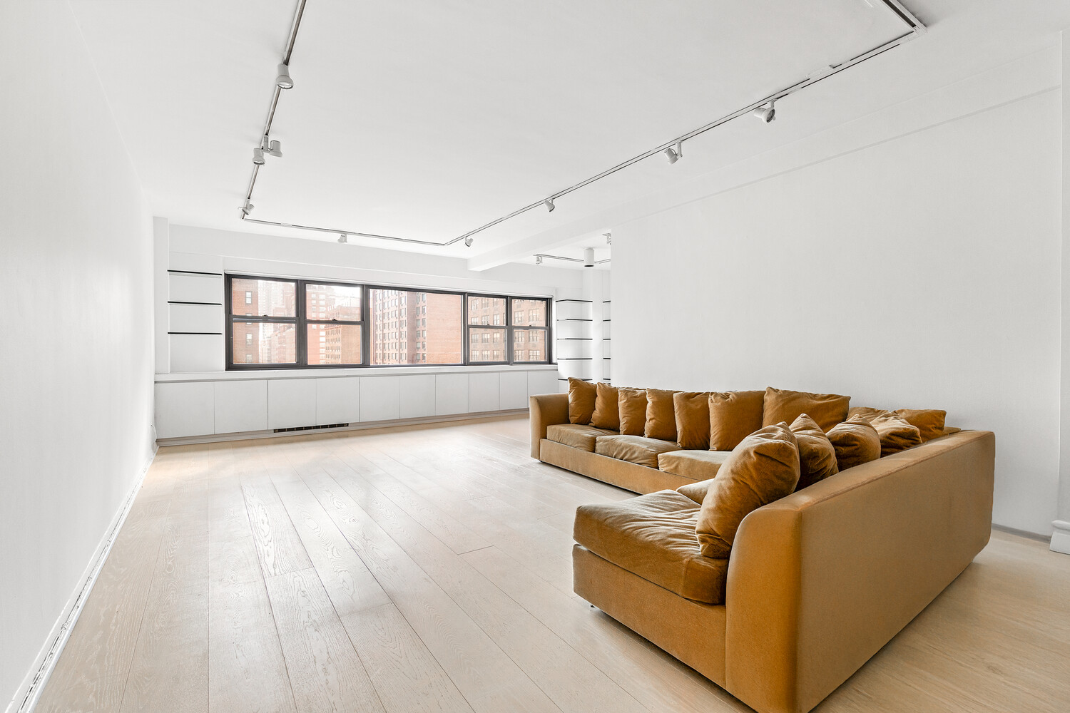 165 East 72nd Street, Unit 11C Manhattan, NY 10021 - Photo 2 of 12 a living room with furniture and wooden floor