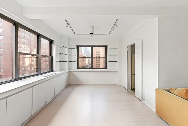 a view of a dining room with furniture and window