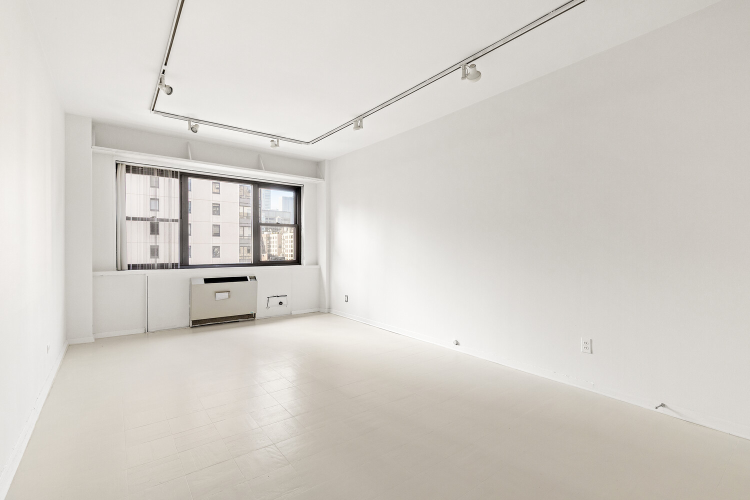 165 East 72nd Street, Unit 11C Manhattan, NY 10021 - Photo 7 of 12 a view of an empty room with a window