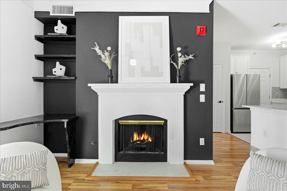 1591 Spring Gate Dr., Unit 3406 McLean, VA 22102 - Photo 11 of 45 a living room with furniture and a fireplace