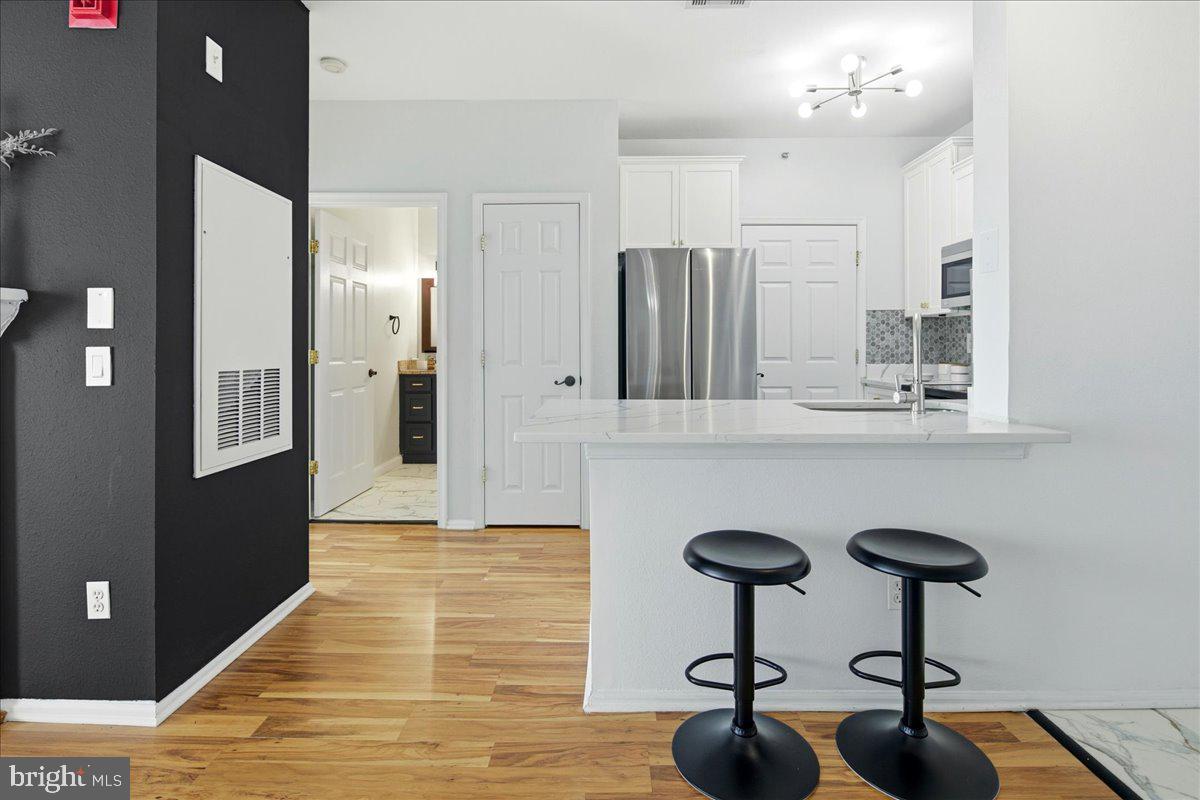 1591 Spring Gate Dr., Unit 3406 McLean, VA 22102 - Photo 17 of 45 a view of kitchen with furniture and wooden floor