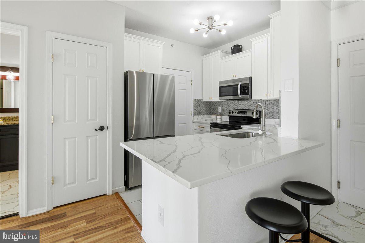 1591 Spring Gate Dr., Unit 3406 McLean, VA 22102 - Photo 18 of 45 a kitchen with stainless steel appliances granite countertop a sink stove and refrigerator