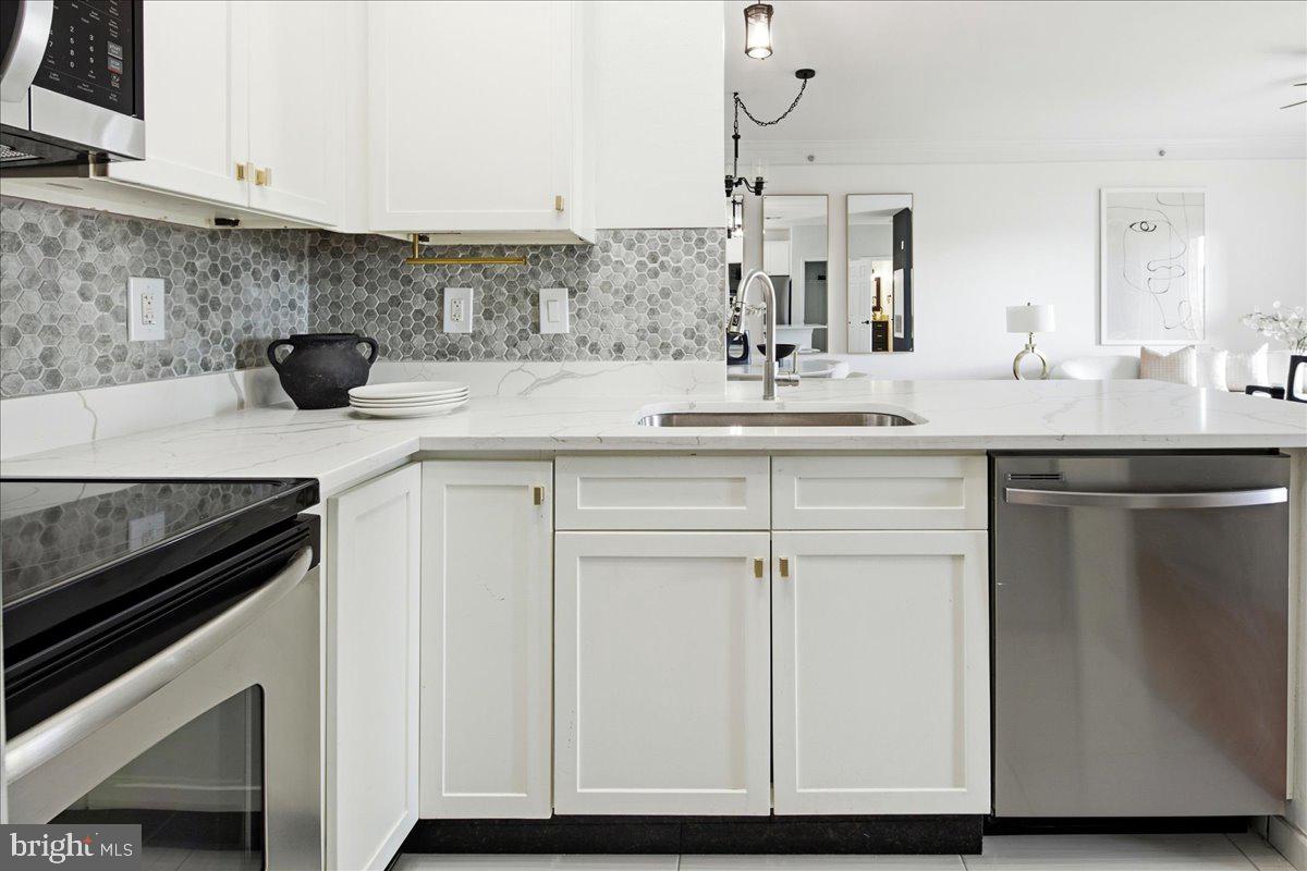 1591 Spring Gate Dr., Unit 3406 McLean, VA 22102 - Photo 24 of 45 a kitchen with cabinets and white appliances