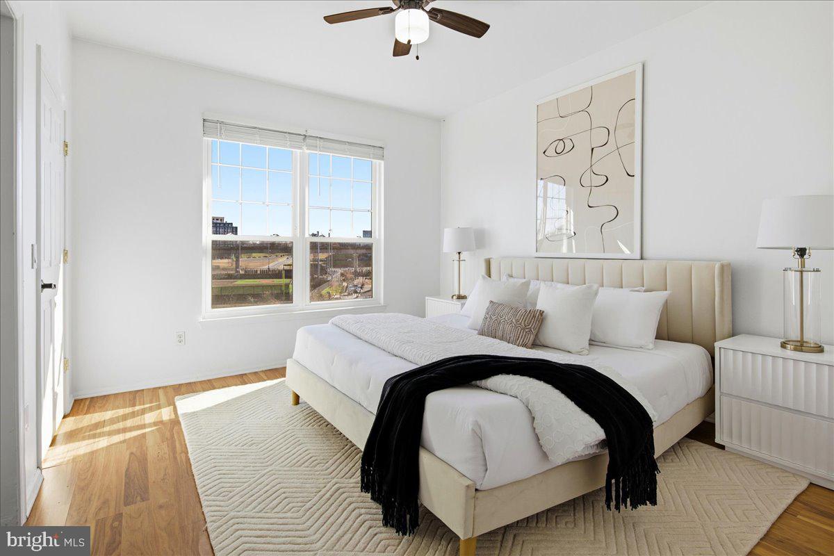 1591 Spring Gate Dr., Unit 3406 McLean, VA 22102 - Photo 26 of 45 a bedroom with a large bed and a chandelier