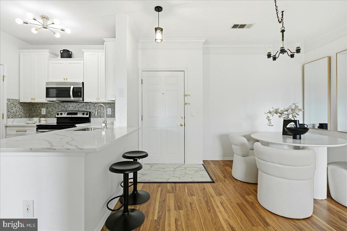 1591 Spring Gate Dr., Unit 3406 McLean, VA 22102 - Photo 3 of 45 a view of kitchen and sink with wooden floor