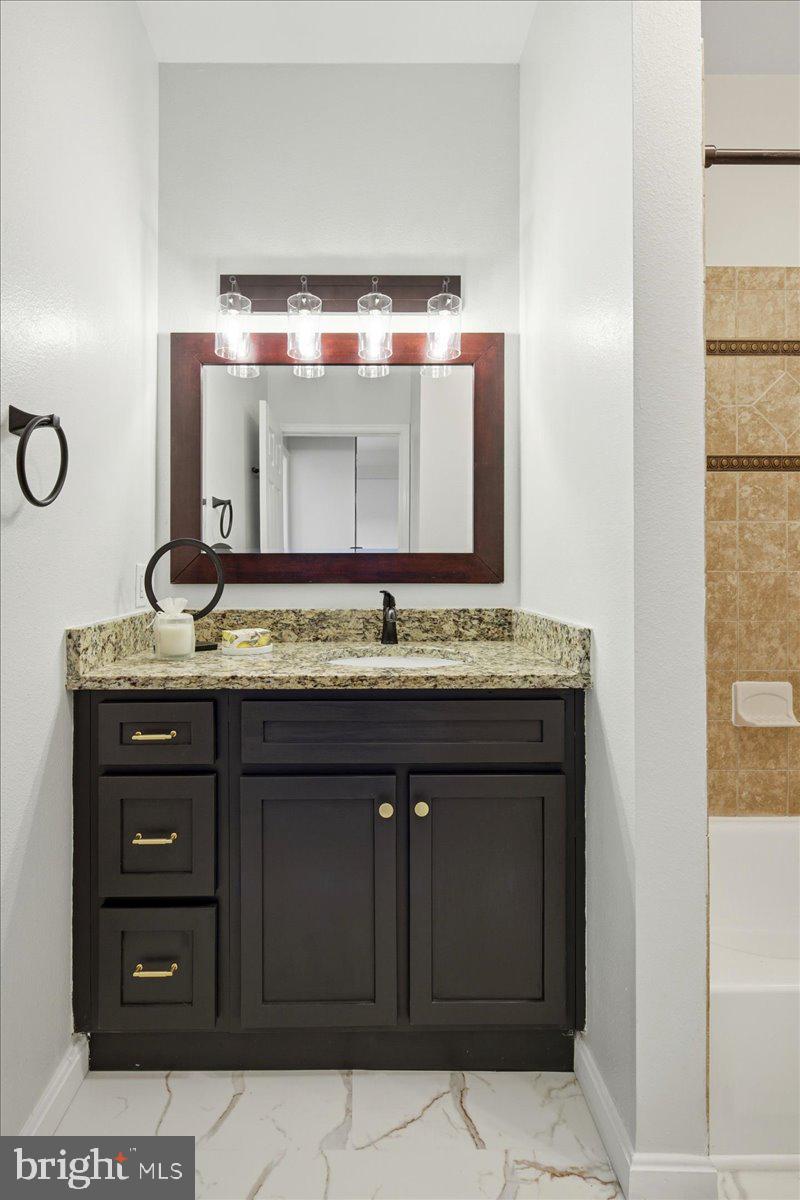 1591 Spring Gate Dr., Unit 3406 McLean, VA 22102 - Photo 33 of 45 a bathroom with a sink and a mirror