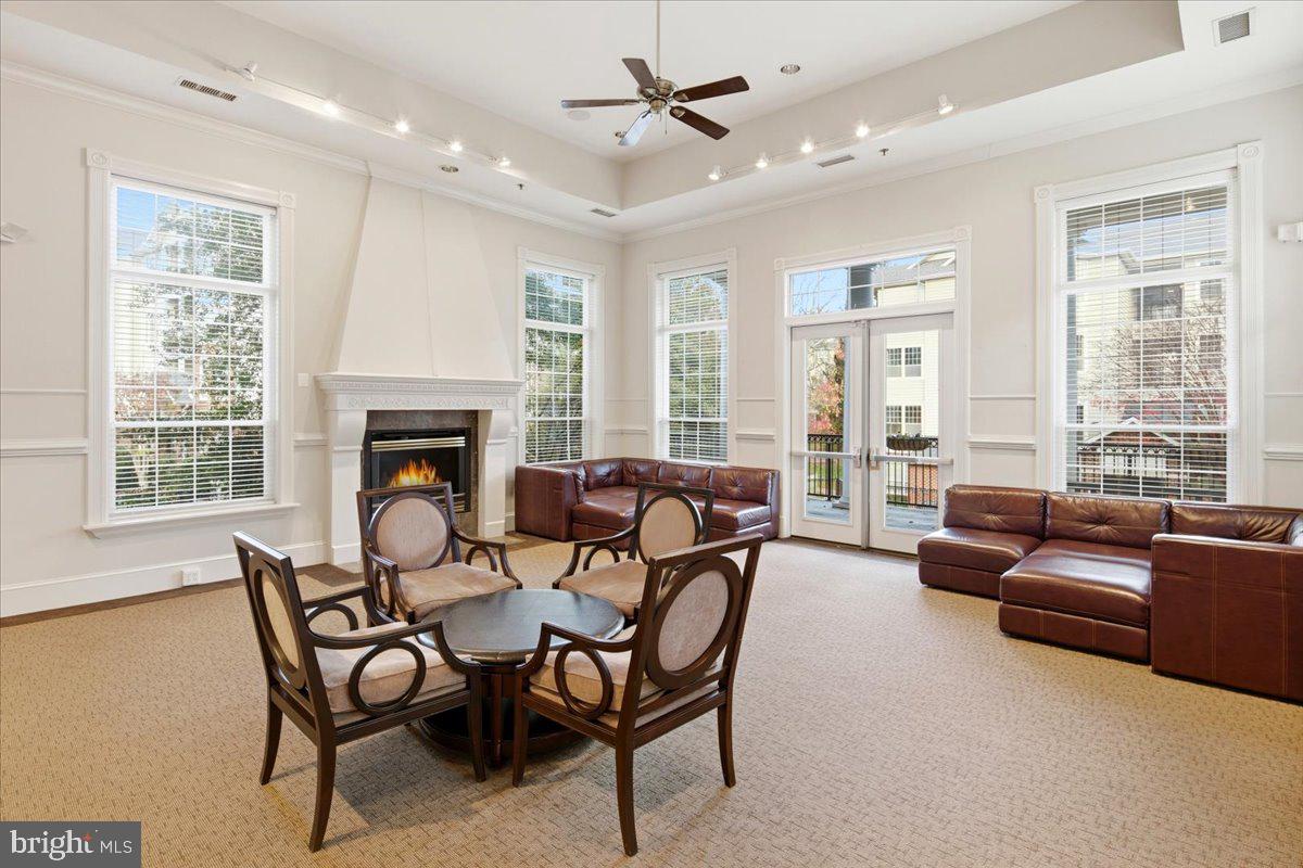 1591 Spring Gate Dr., Unit 3406 McLean, VA 22102 - Photo 42 of 45 a dining room with furniture a fireplace and wooden floor