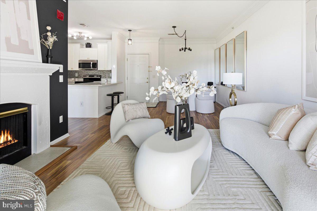 1591 Spring Gate Dr., Unit 3406 McLean, VA 22102 - Photo 9 of 45 a living room with furniture and a fireplace