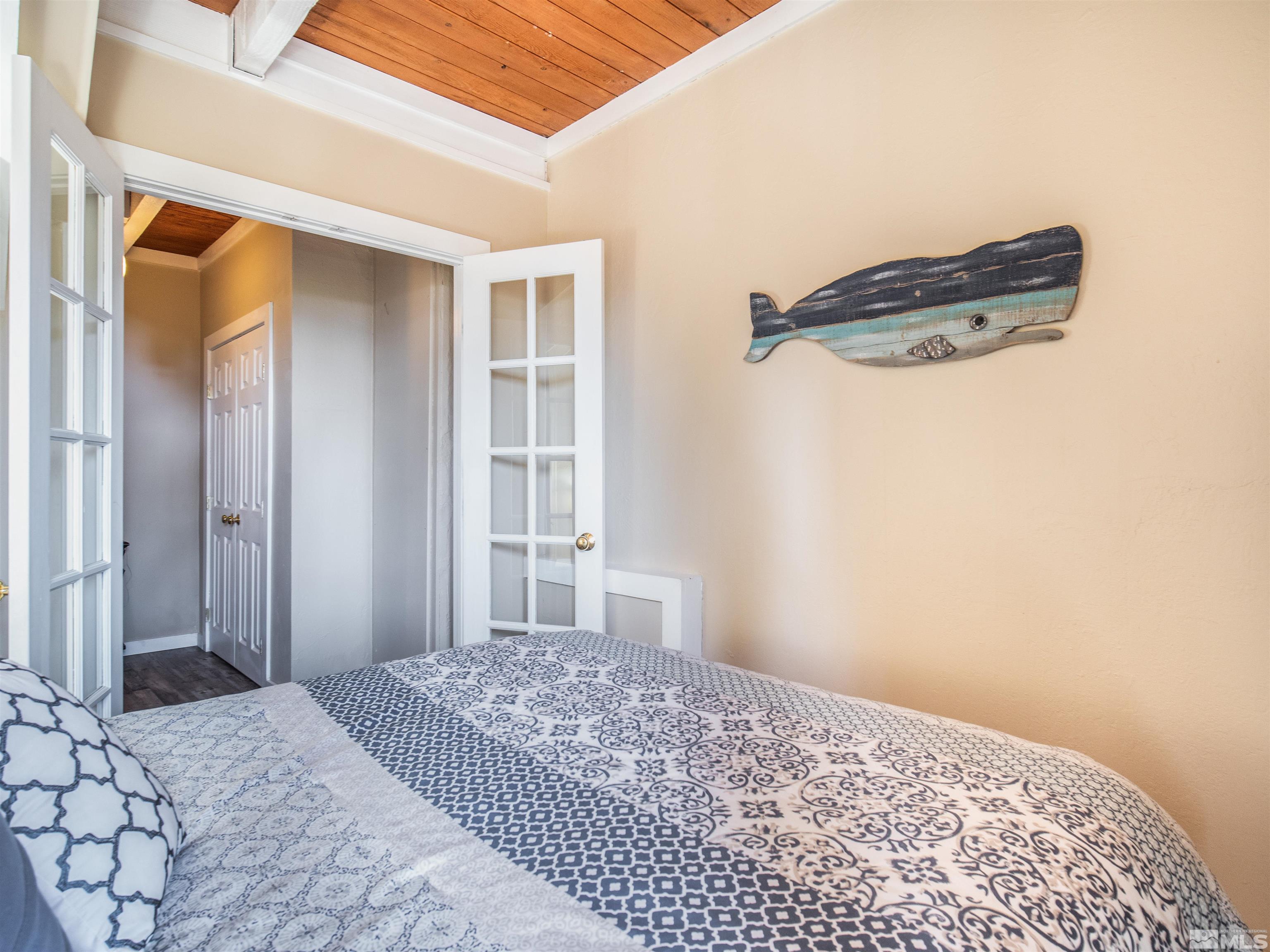 111 Tramway Drive, Unit 2 Stateline, NV 89449 - Photo 14 of 37 a bedroom with a bed and a window