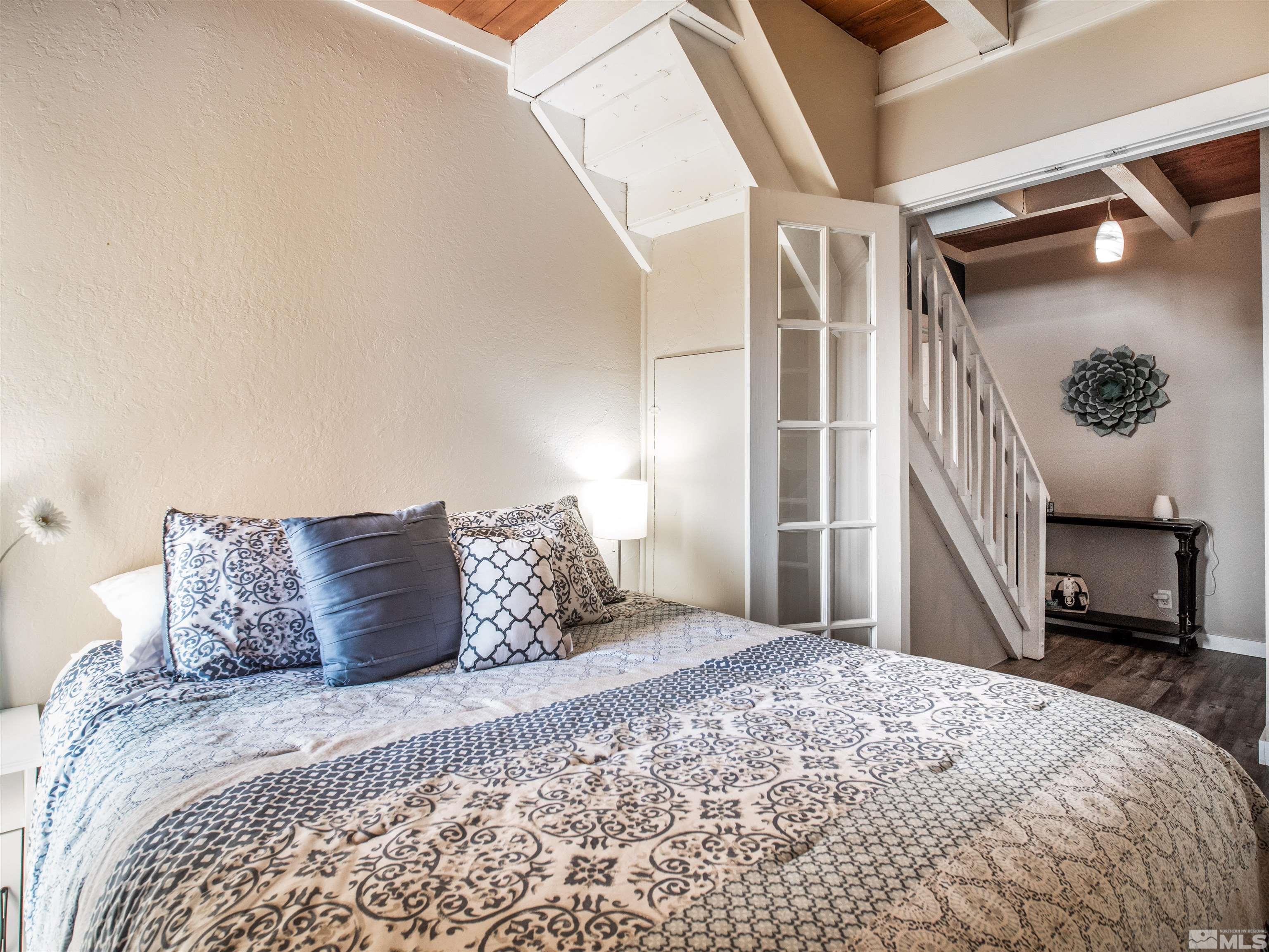 111 Tramway Drive, Unit 2 Stateline, NV 89449 - Photo 15 of 37 a bedroom with a bed and a mirror