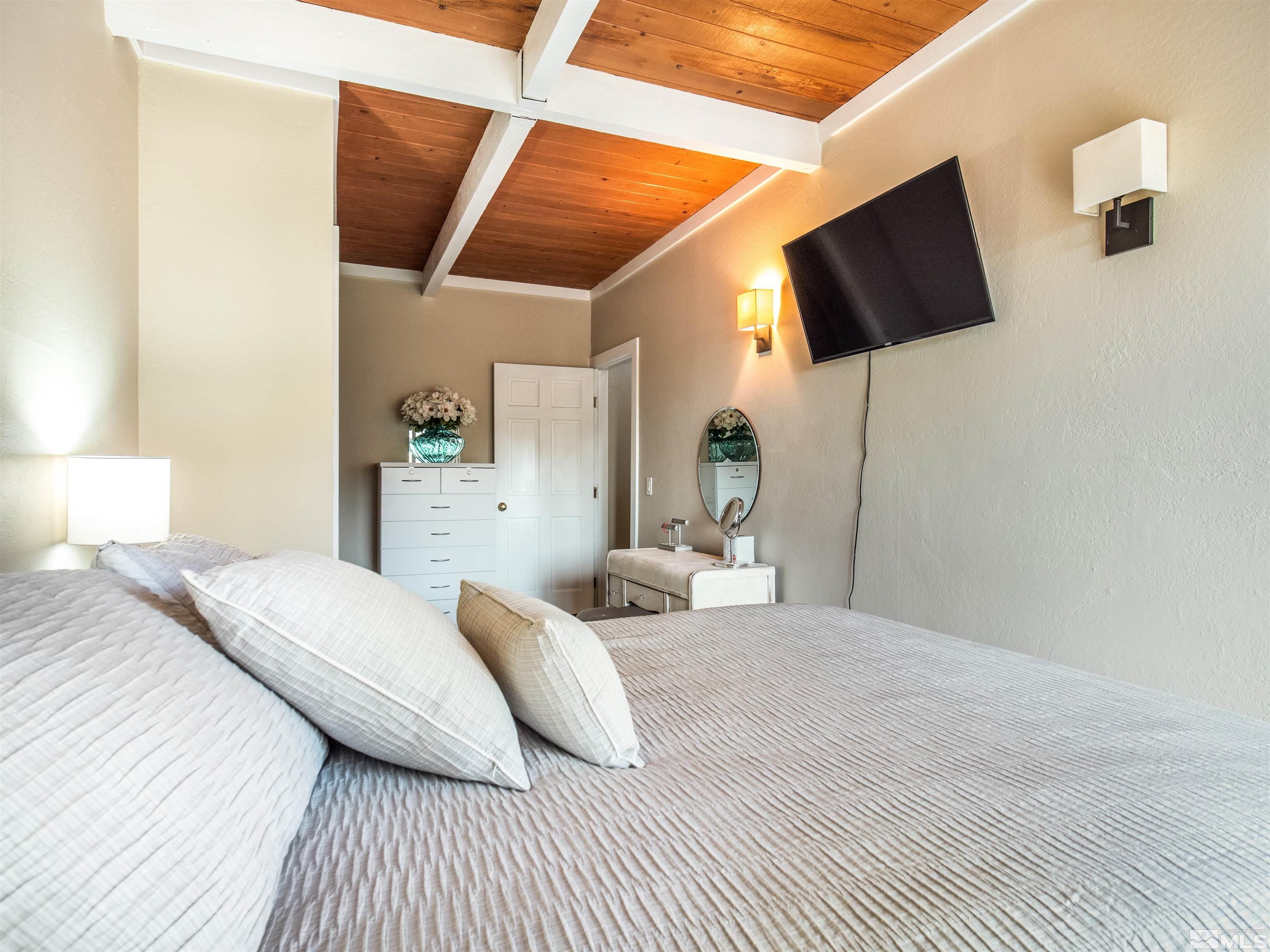 111 Tramway Drive, Unit 2 Stateline, NV 89449 - Photo 16 of 37 a bedroom with a bed and a flat screen tv