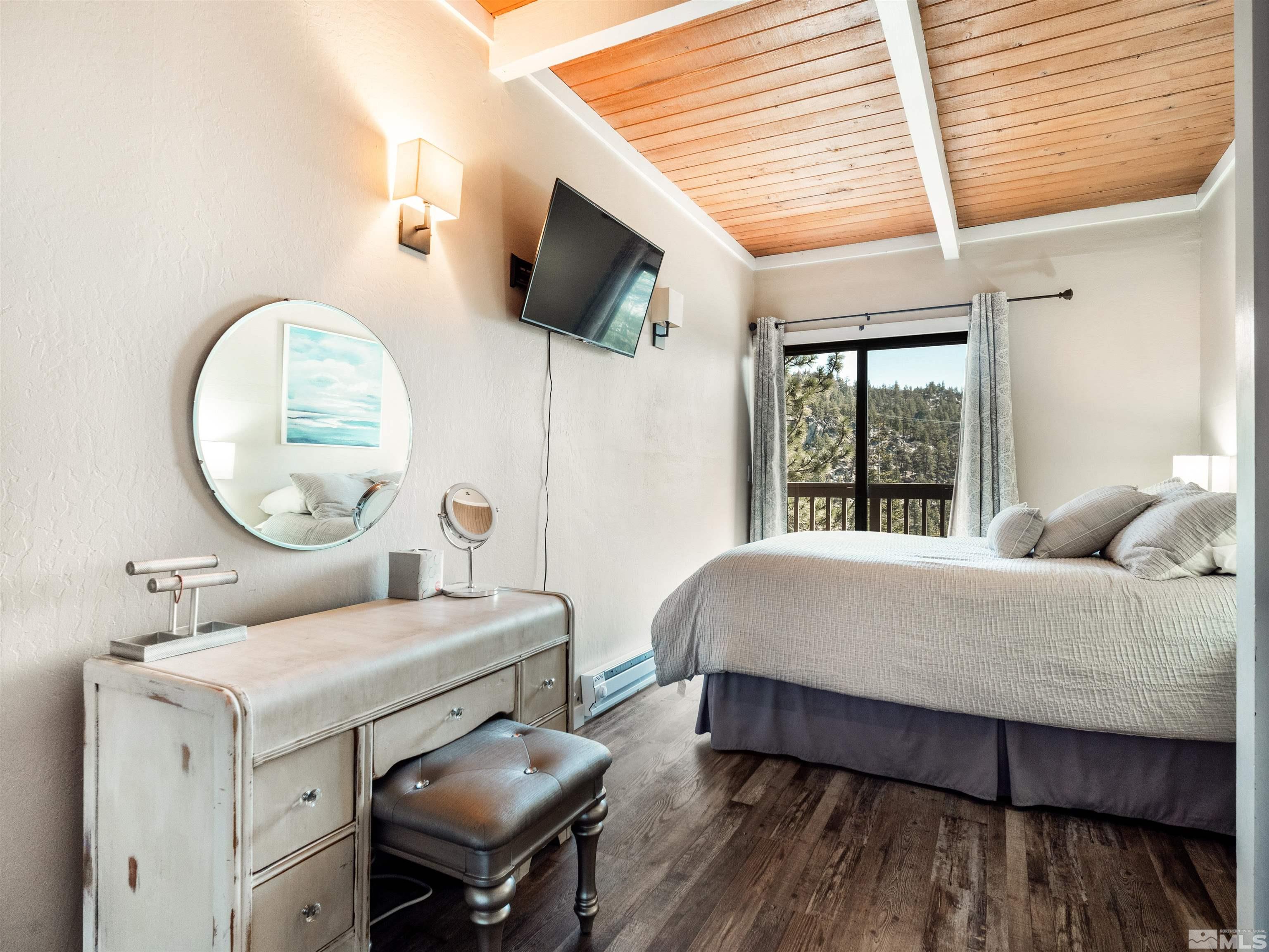 111 Tramway Drive, Unit 2 Stateline, NV 89449 - Photo 17 of 37 a living room with a bed furniture and a large window
