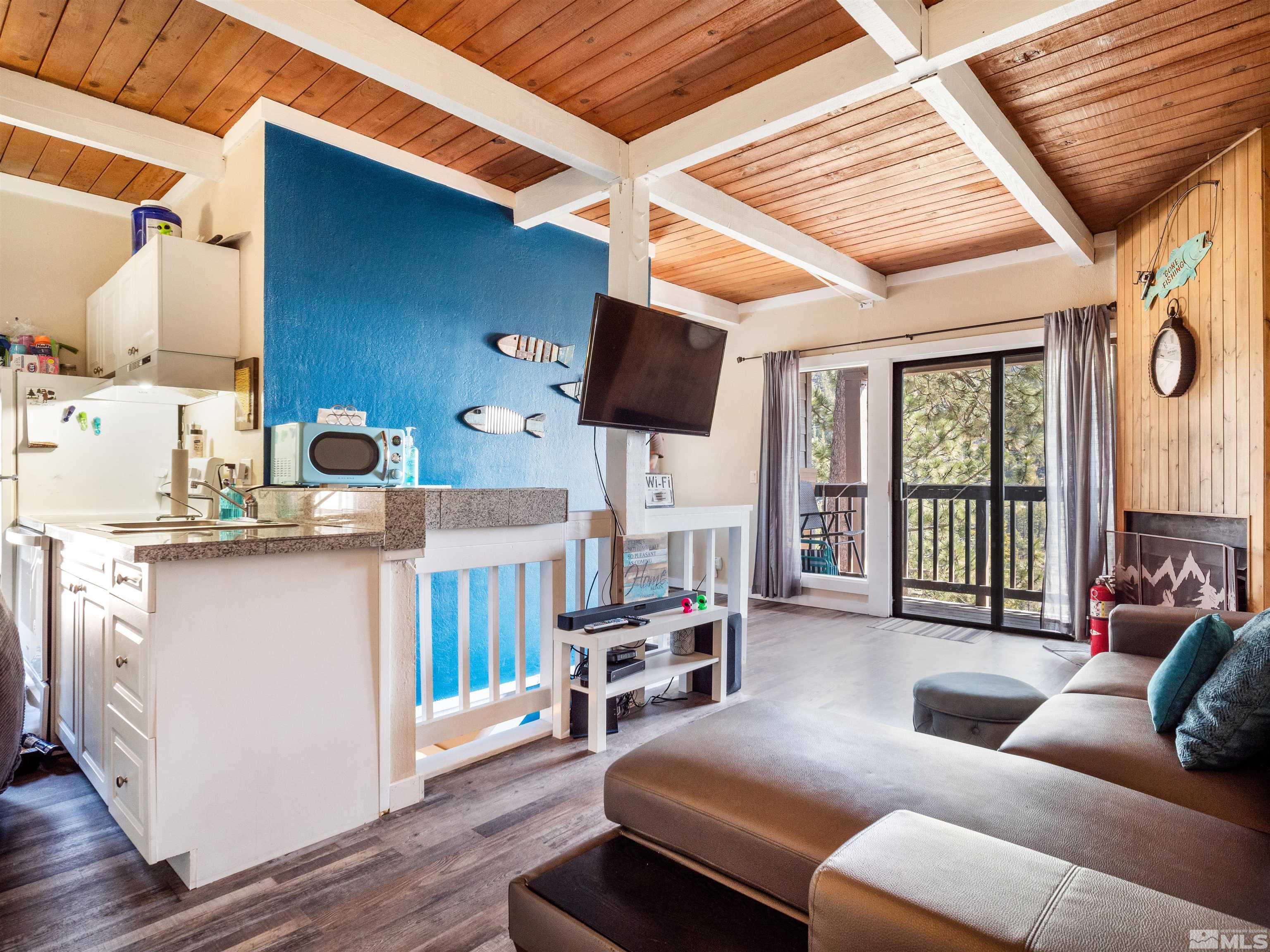 111 Tramway Drive, Unit 2 Stateline, NV 89449 - Photo 4 of 37 a living room with furniture and a flat screen tv