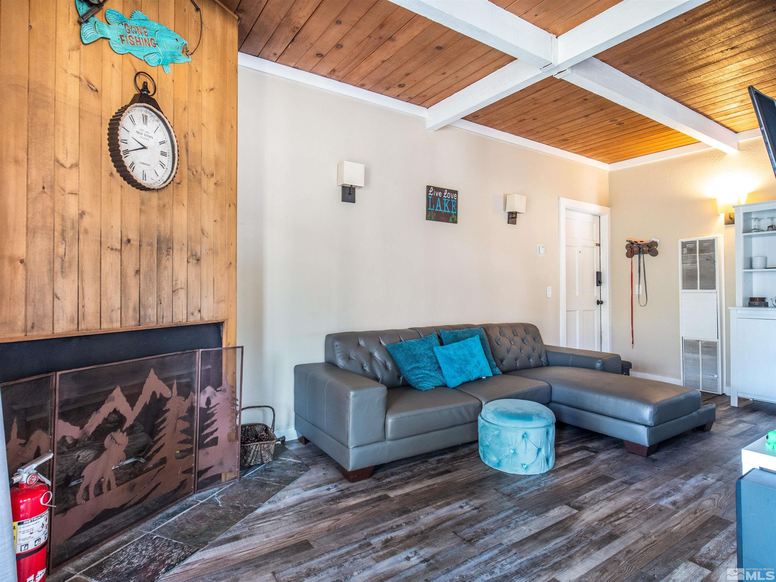 111 Tramway Drive, Unit 2 Stateline, NV 89449 - Photo 6 of 37 a living room with furniture a rug and a wall painting