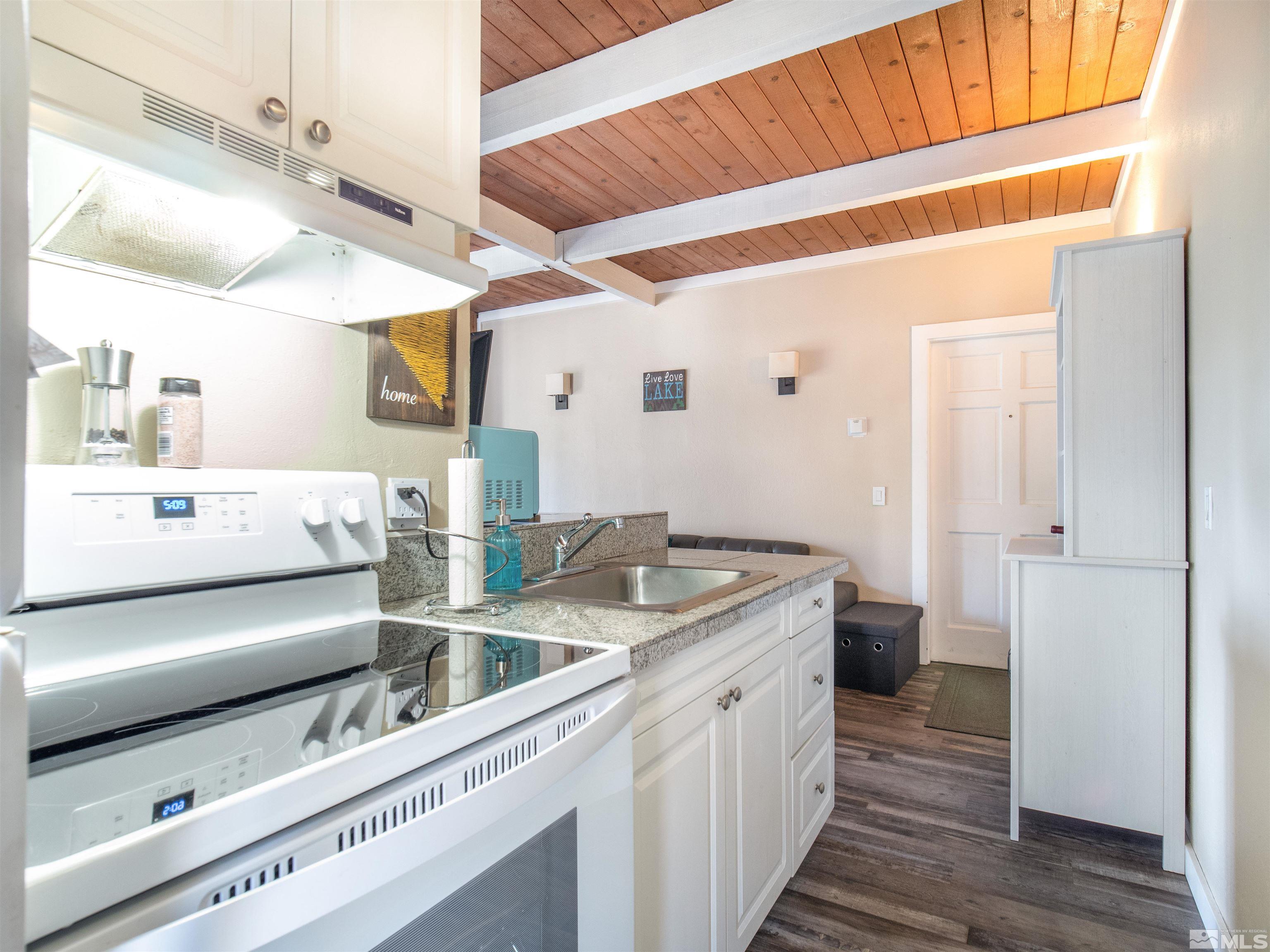 111 Tramway Drive, Unit 2 Stateline, NV 89449 - Photo 9 of 37 a kitchen with a sink and a refrigerator