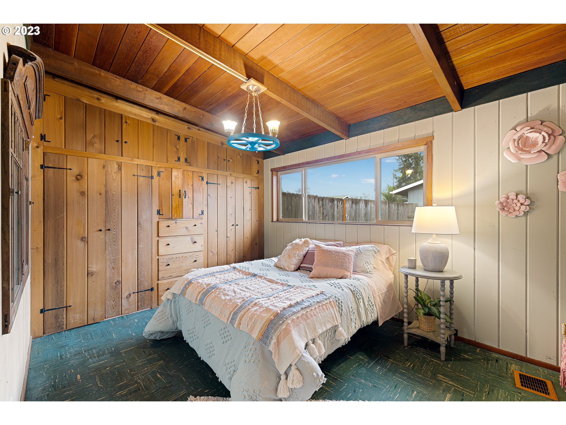 2635 Nova Street Springfield, OR 97477 - Photo 24 of 31 a bedroom with a bed and a chandelier