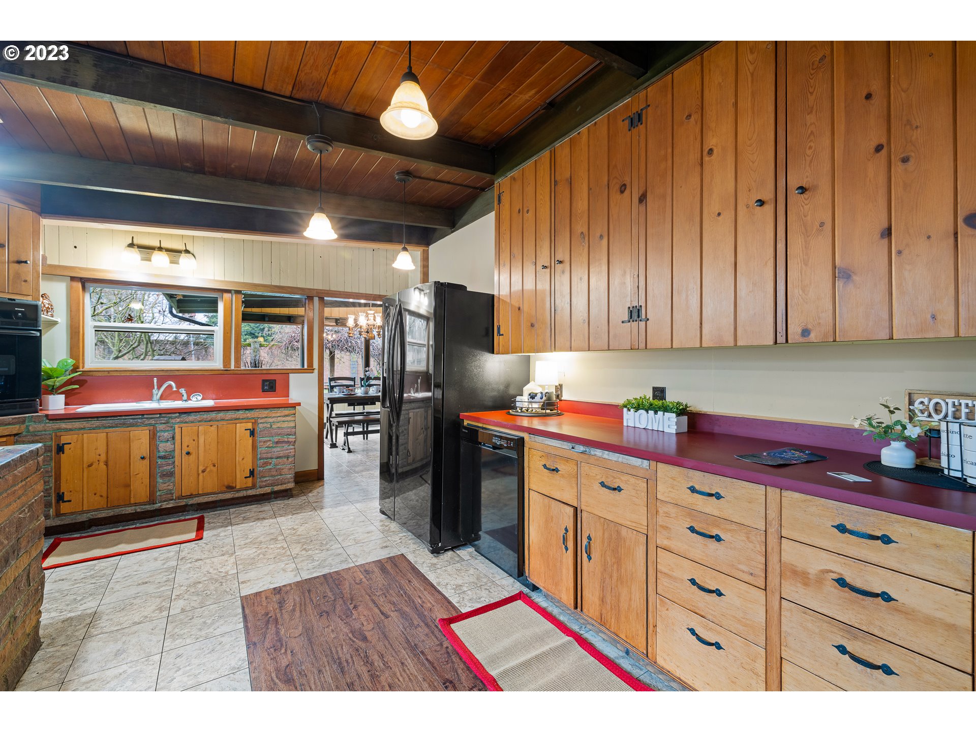 2635 Nova Street Springfield, OR 97477 - Photo 9 of 31 a kitchen with stainless steel appliances kitchen island granite countertop a refrigerator and a wooden cabinets