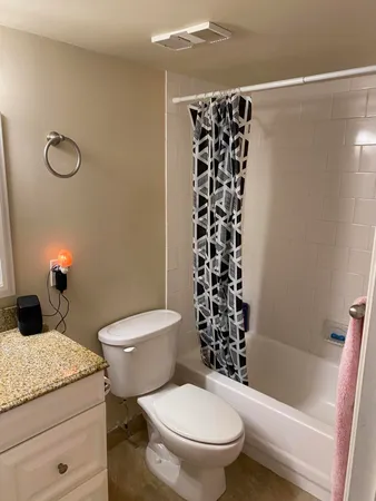 an empty room with closet and a bathroom