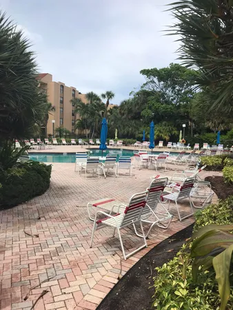 a view of a swimming pool with chairs in patio