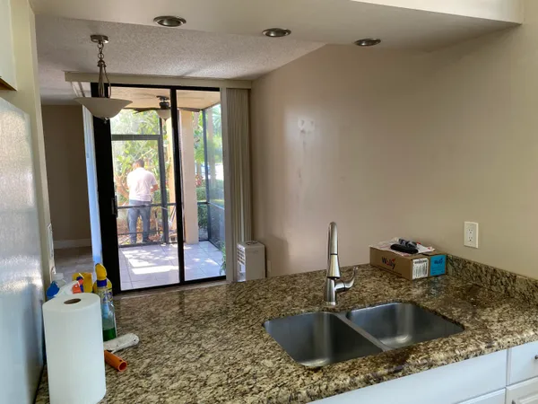 a kitchen with a sink and large window