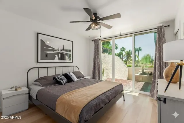 a bedroom with a bed and a large window