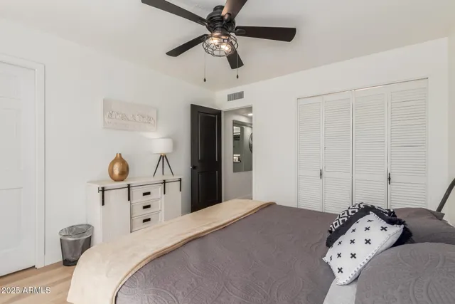 a bedroom with a bed and a chandelier