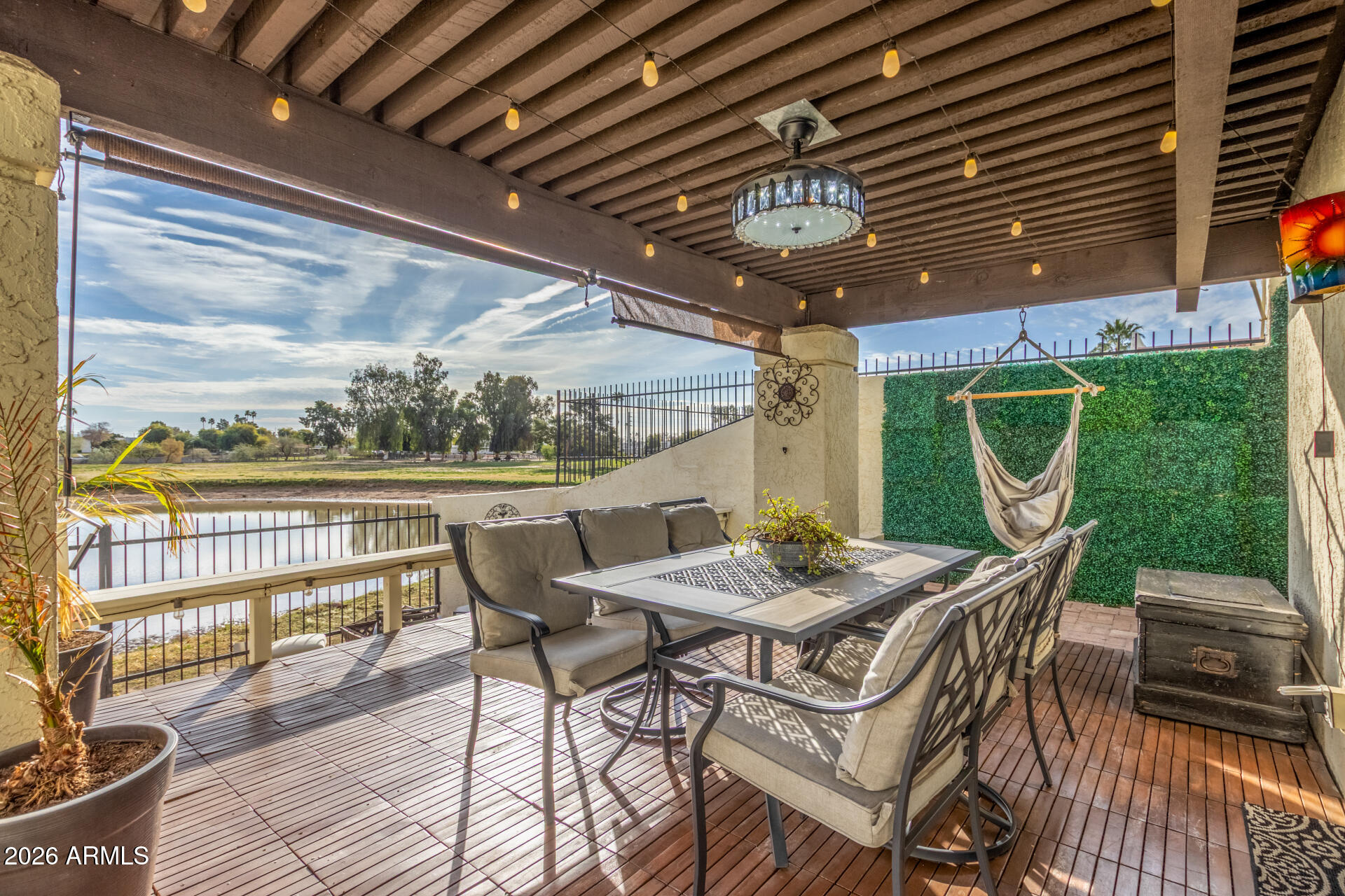 2529 North Miller Road Scottsdale, AZ 85257 - Photo 22 of 65 a view of a patio with table and chairs with wooden floor and fence