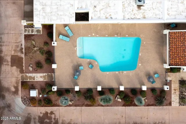 an aerial view of a house with pool