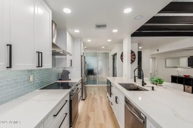 a kitchen with a sink stove and refrigerator