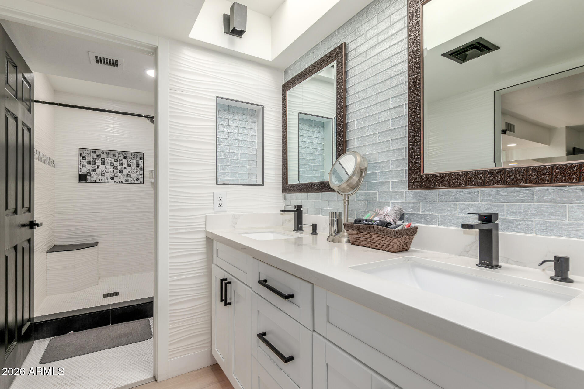 2529 North Miller Road Scottsdale, AZ 85257 - Photo 35 of 65 a bathroom with a sink and a mirror