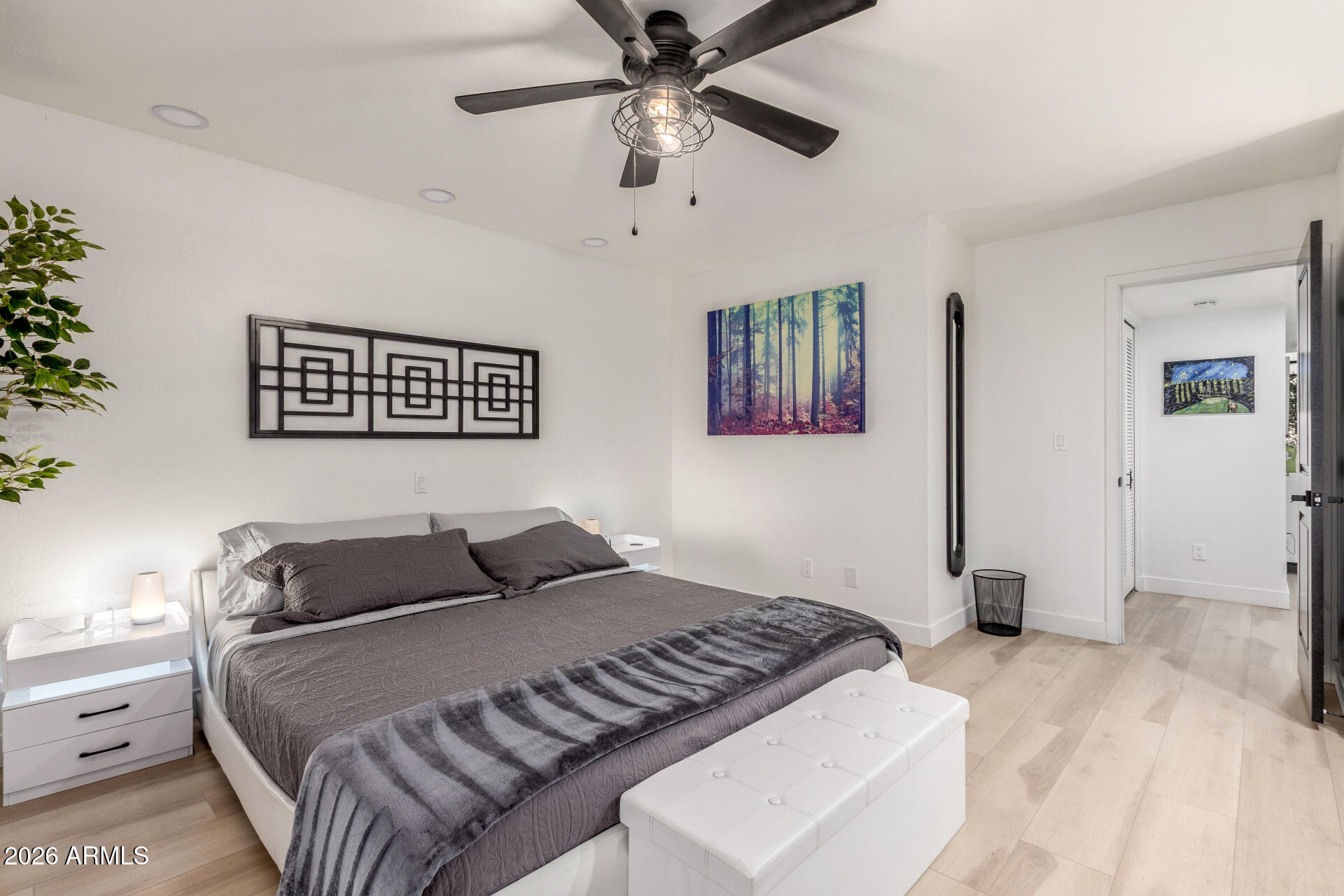 2529 North Miller Road Scottsdale, AZ 85257 - Photo 37 of 65 a bedroom with a large bed and a chandelier