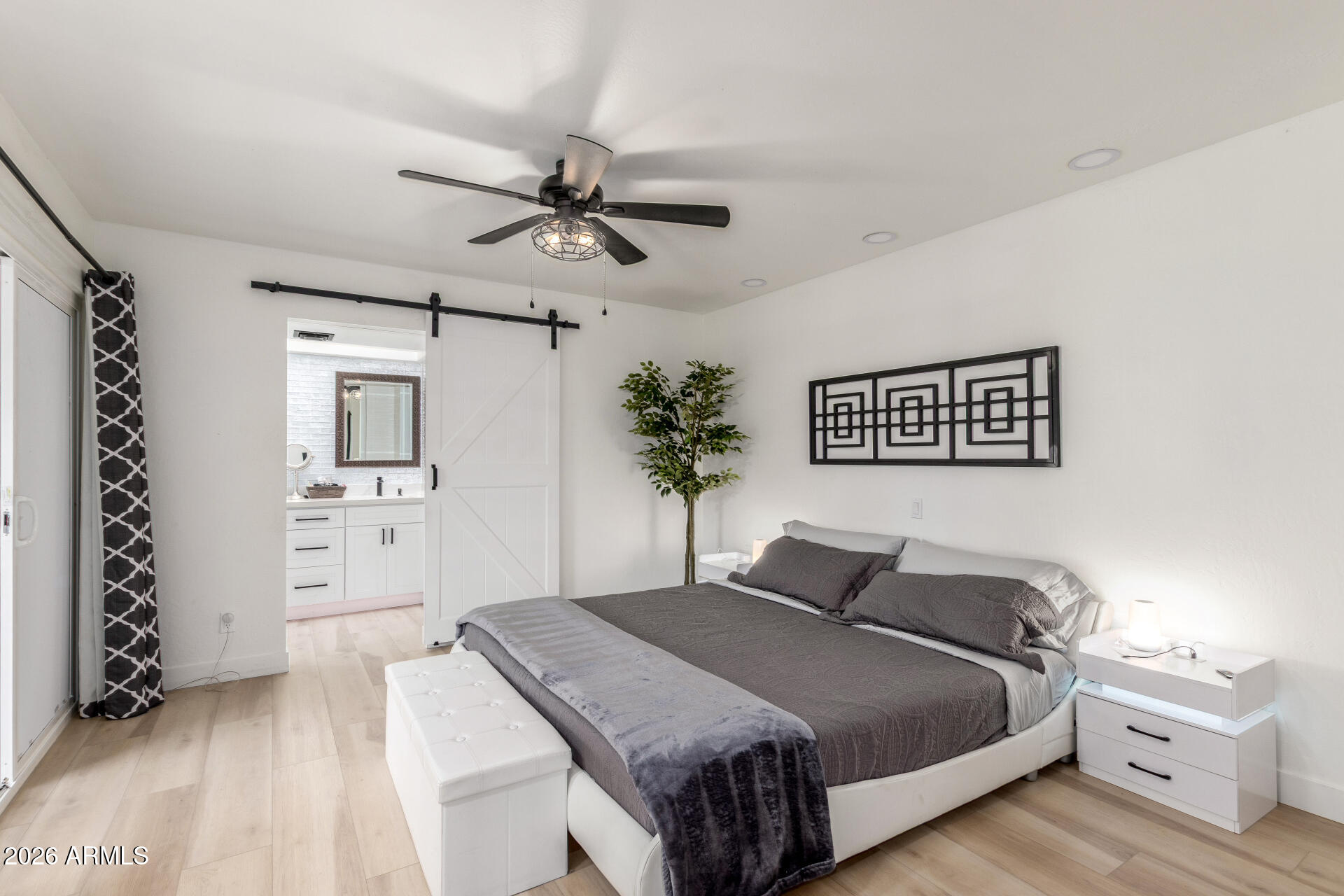 2529 North Miller Road Scottsdale, AZ 85257 - Photo 39 of 65 a bedroom with a large bed and a chandelier