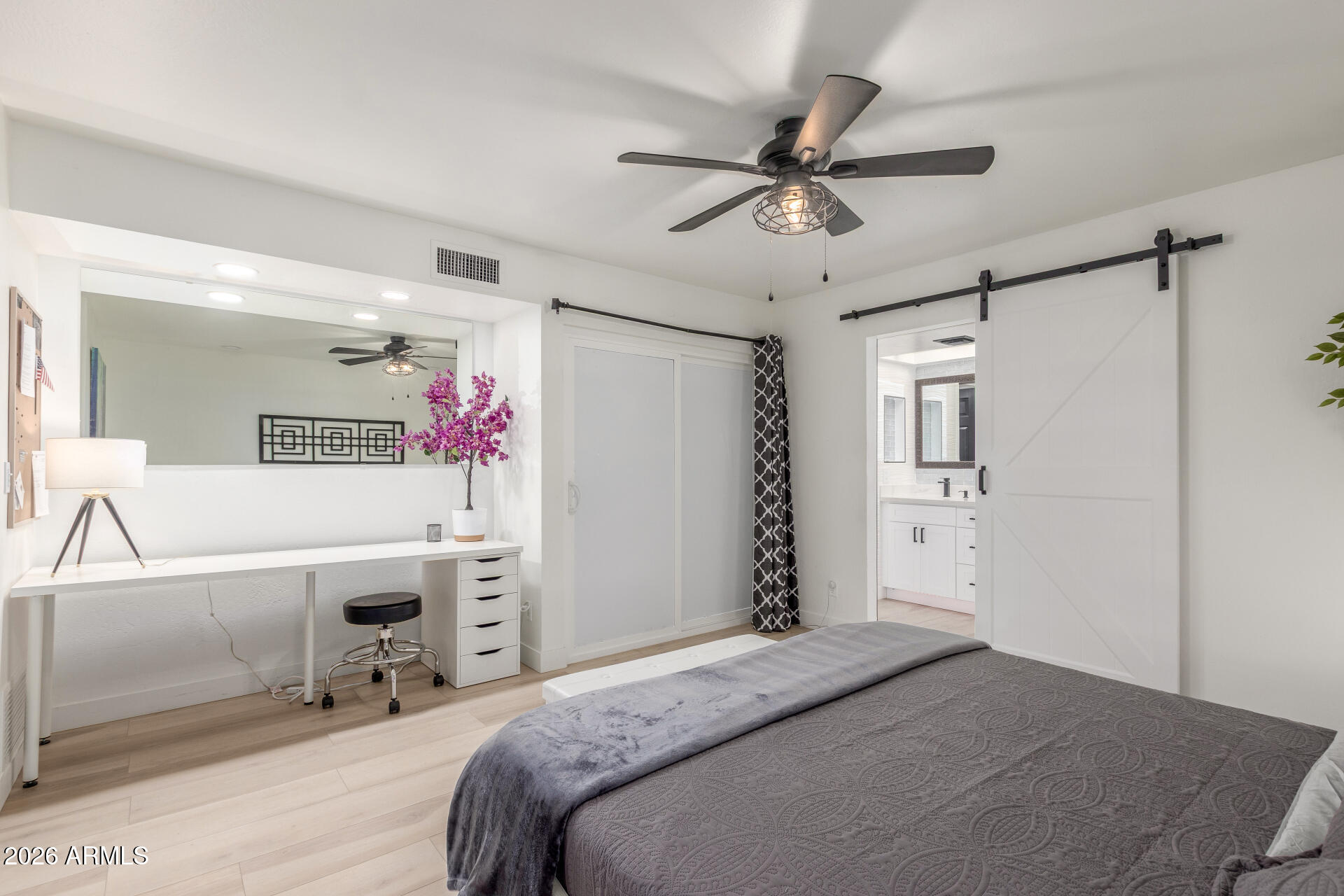 2529 North Miller Road Scottsdale, AZ 85257 - Photo 40 of 65 a bedroom with a bed a desk and chair