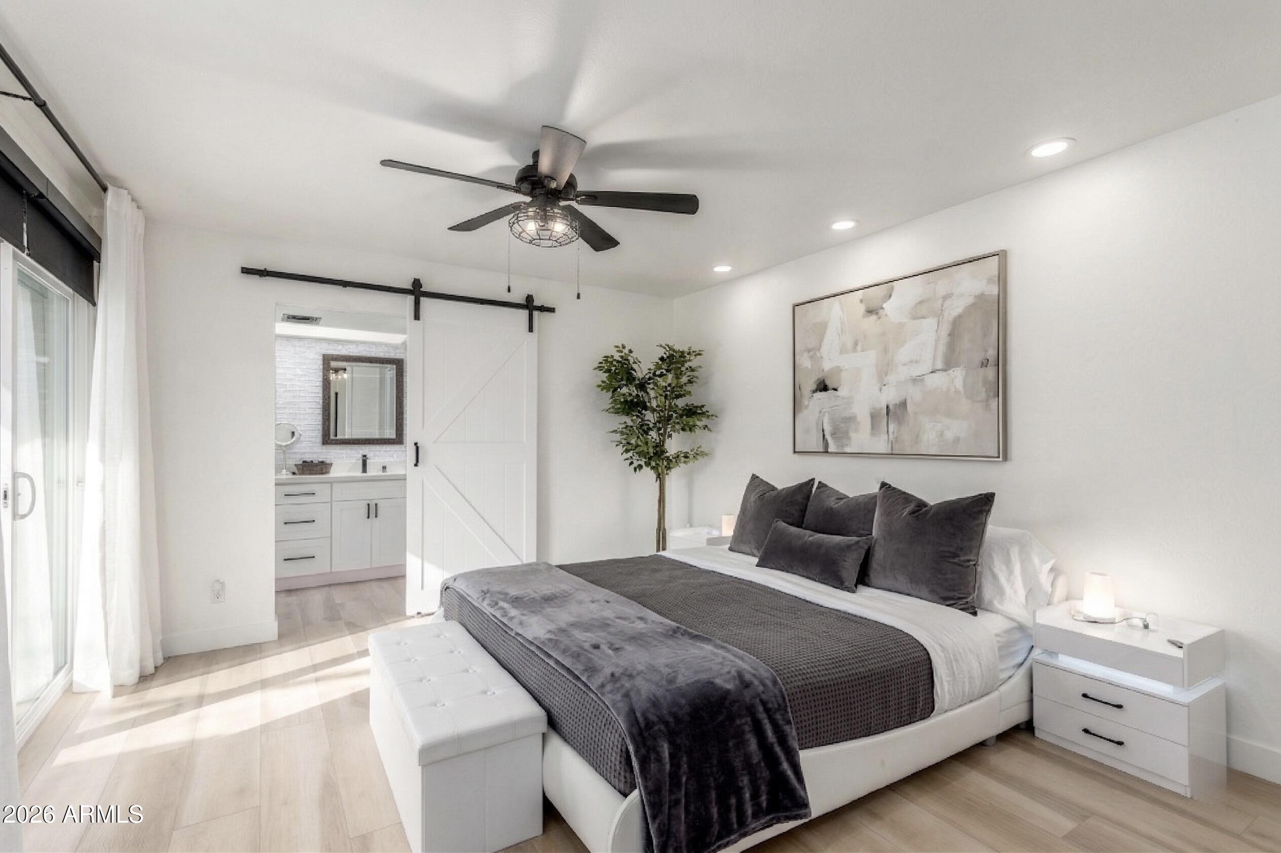 2529 North Miller Road Scottsdale, AZ 85257 - Photo 4 of 65 a bedroom with a large bed and a chandelier