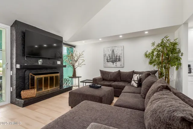 a living room with furniture and a fireplace