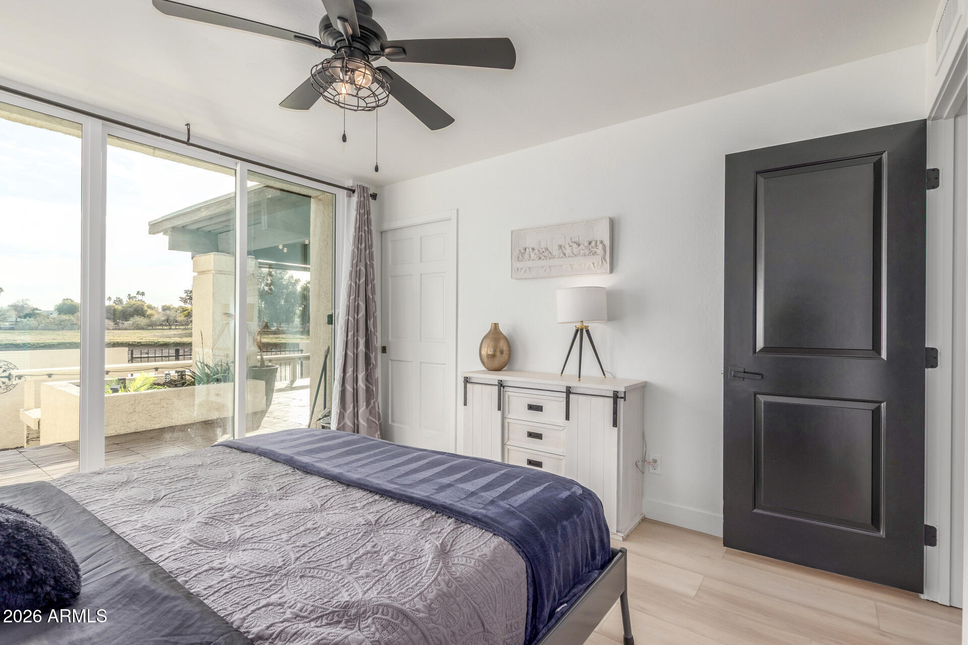 2529 North Miller Road Scottsdale, AZ 85257 - Photo 49 of 65 a bedroom with a bed and a large window