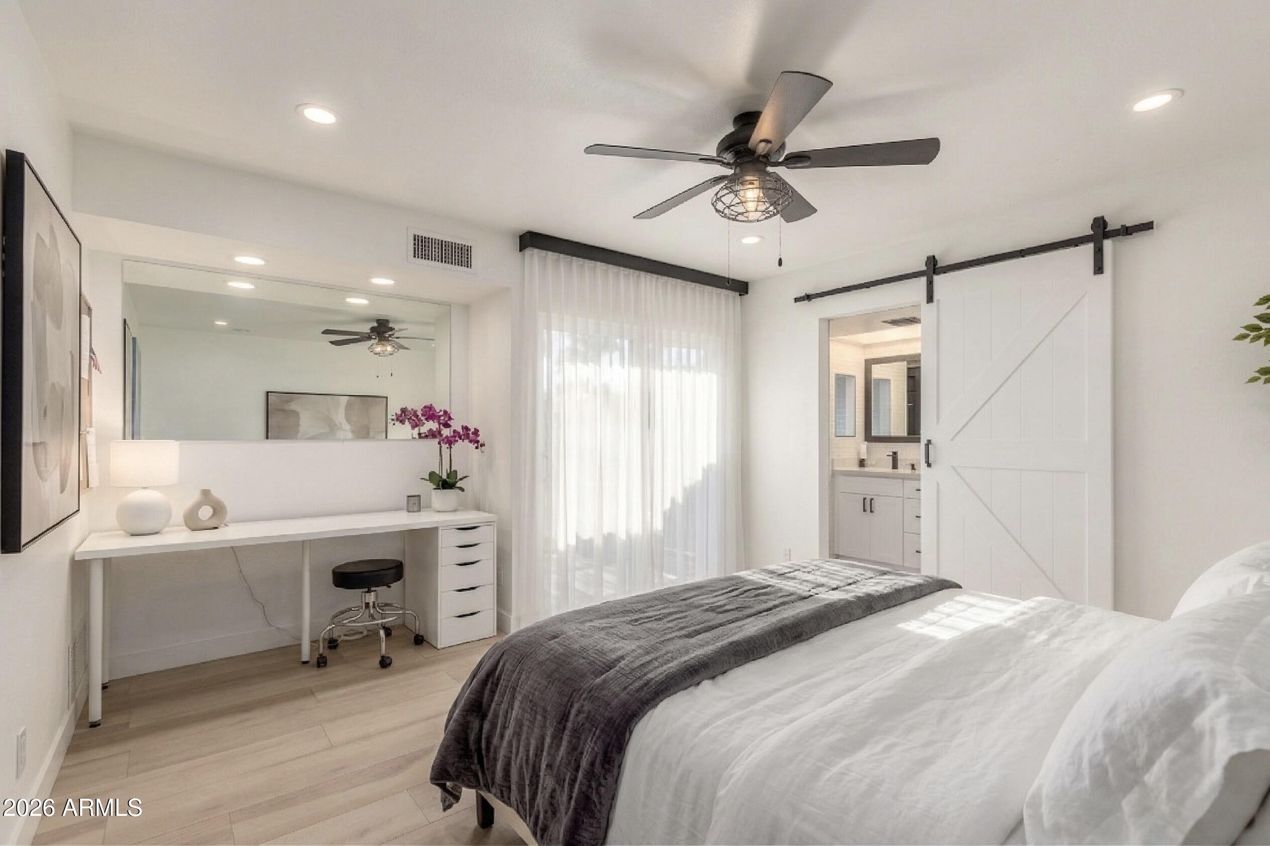 2529 North Miller Road Scottsdale, AZ 85257 - Photo 5 of 65 a bedroom with a bed a desk and chair