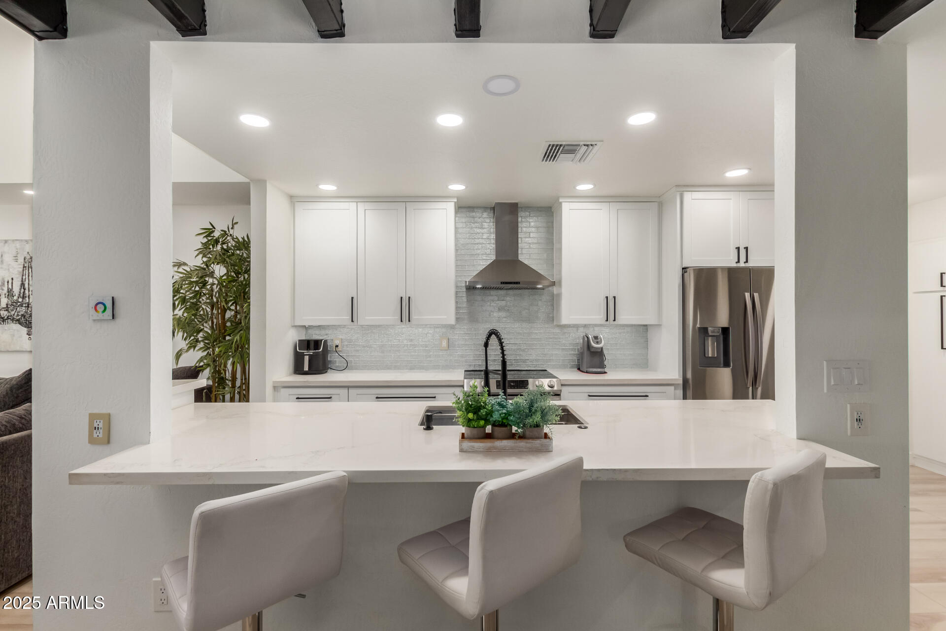 2529 North Miller Road Scottsdale, AZ 85257 - Photo 9 of 65 a kitchen with stainless steel appliances kitchen island granite countertop a sink and a refrigerator