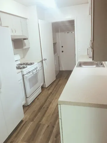 a room with a stove and a refrigerator