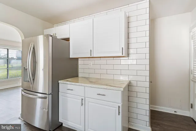 a kitchen with stainless steel appliances a refrigerator and cabinets
