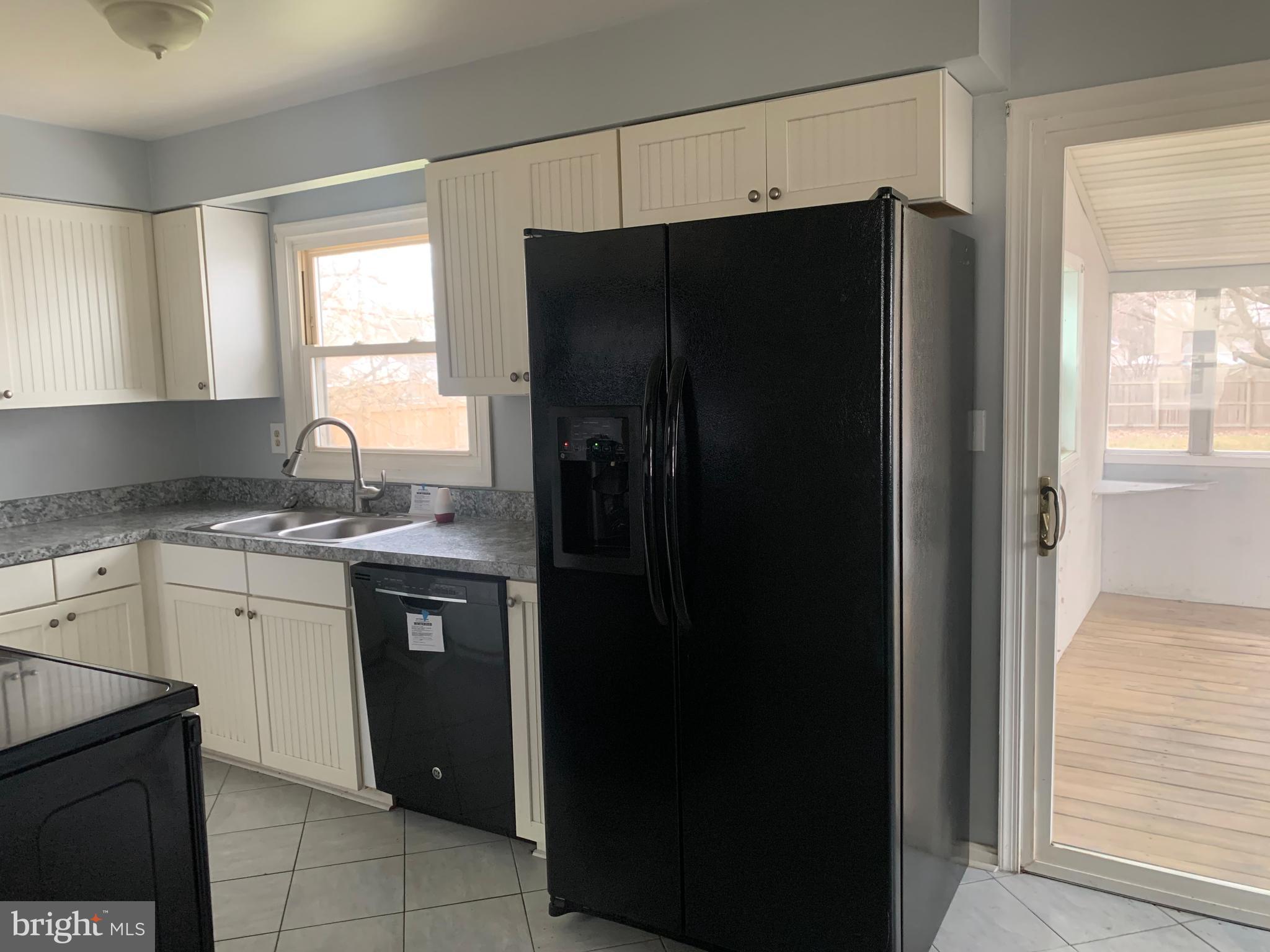 5866 Deale Churchton Road Deale, MD 20751 - Photo 13 of 26 a kitchen with a refrigerator and a sink