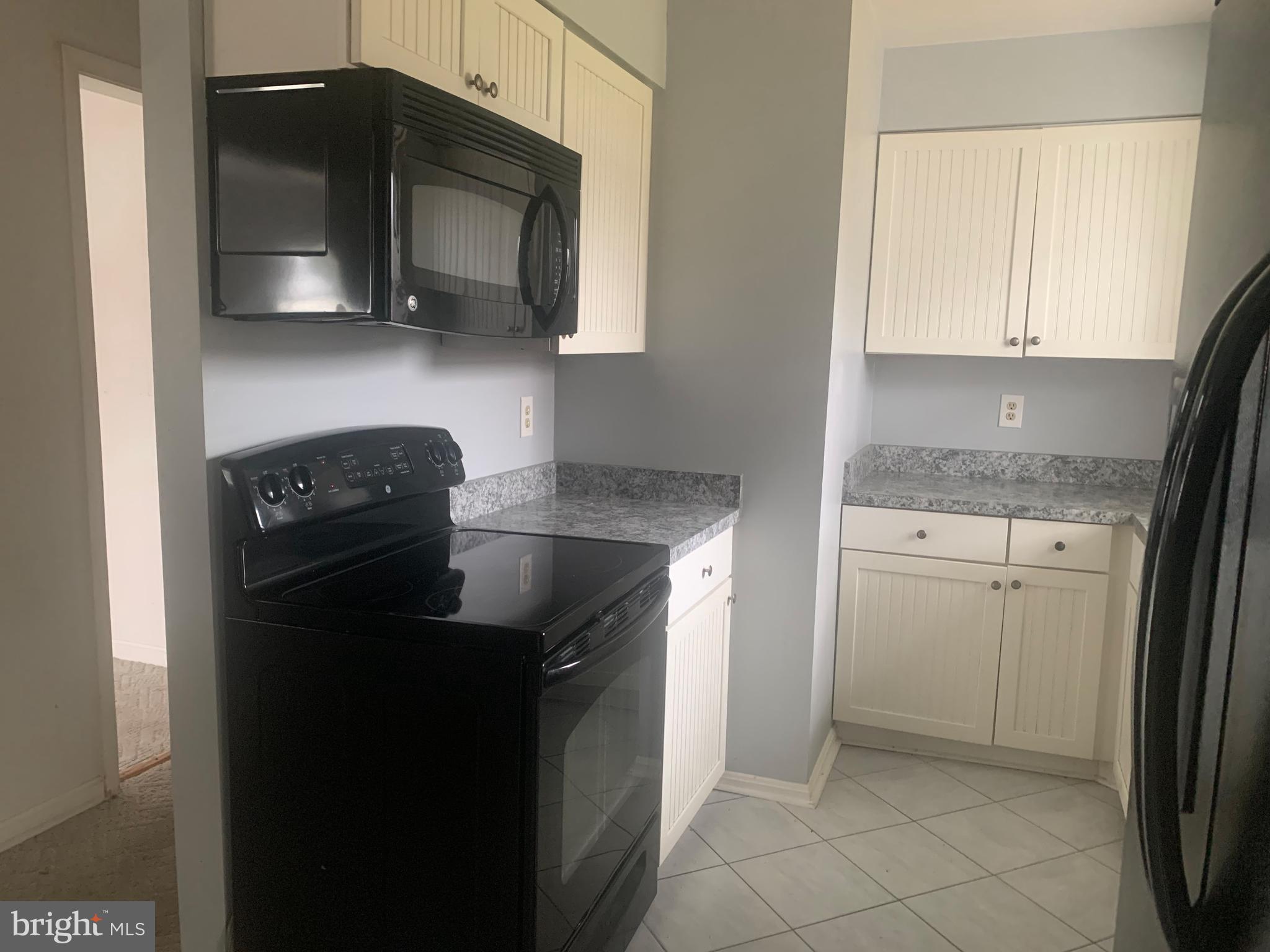 5866 Deale Churchton Road Deale, MD 20751 - Photo 15 of 26 a kitchen with a sink a stove and cabinets